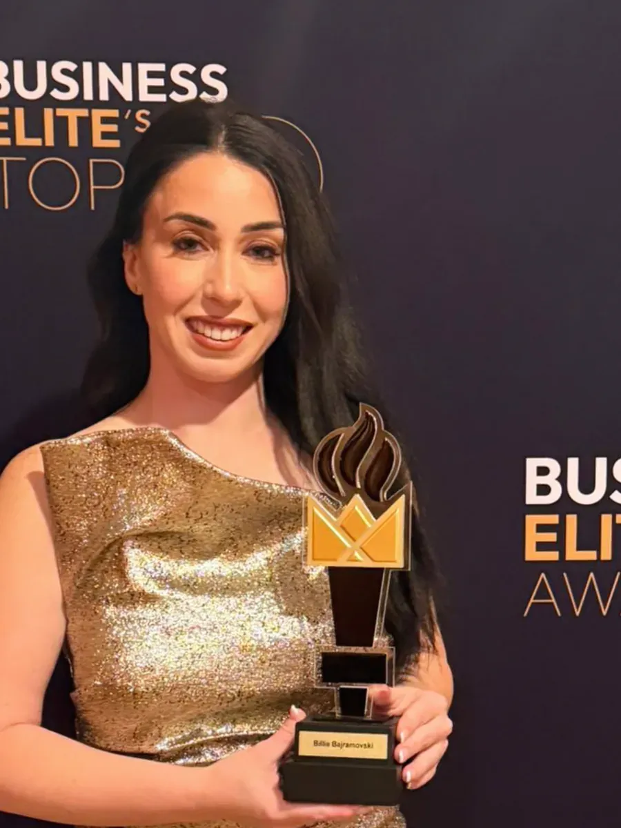 Billie Bajramovski, founder of SOUL IV, holding her Business Elite Awards trophy.