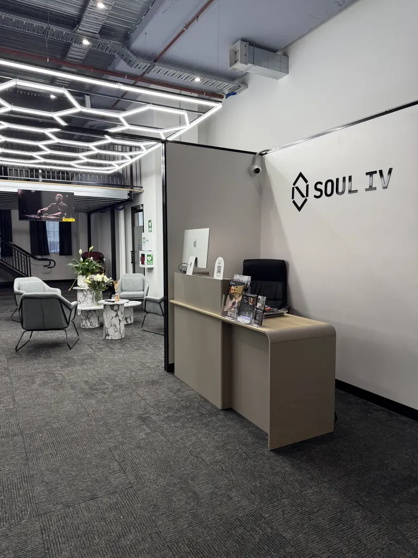 SOUL IV Melbourne CBD clinic reception, with the SOUL IV logo on the wall above the welcome desk