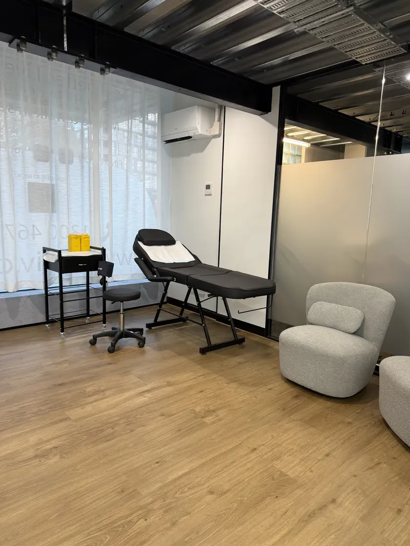 SOUL IV clinic treatment room with a reclining chair, IV stand and natural light through sheer curtains
